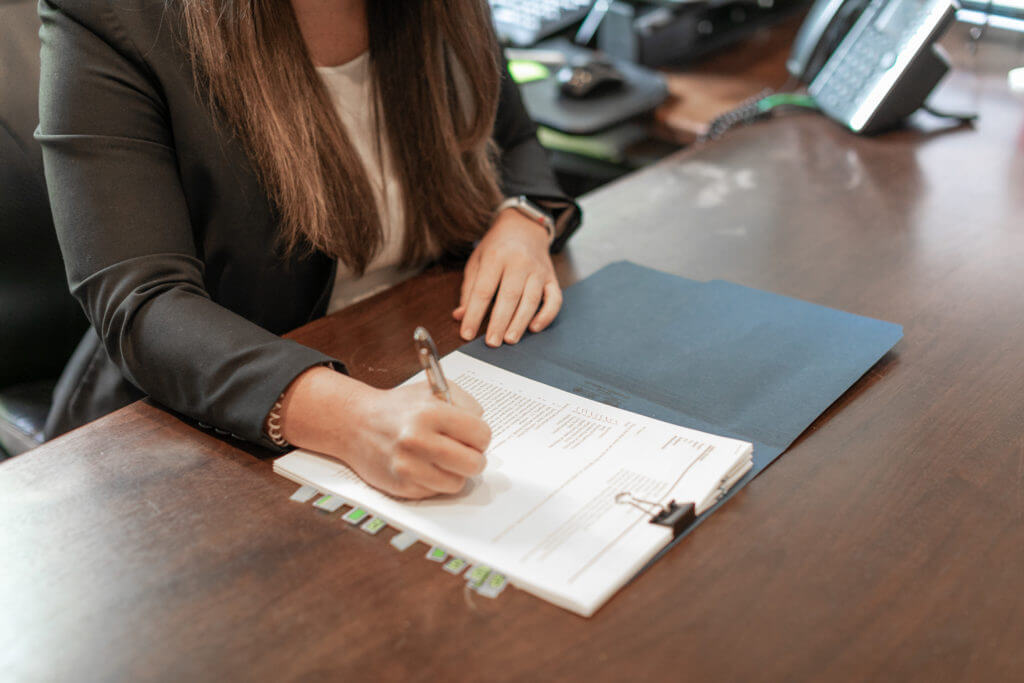 Legal professional at Ecton Law Firm, P.A. reviewing case documents.