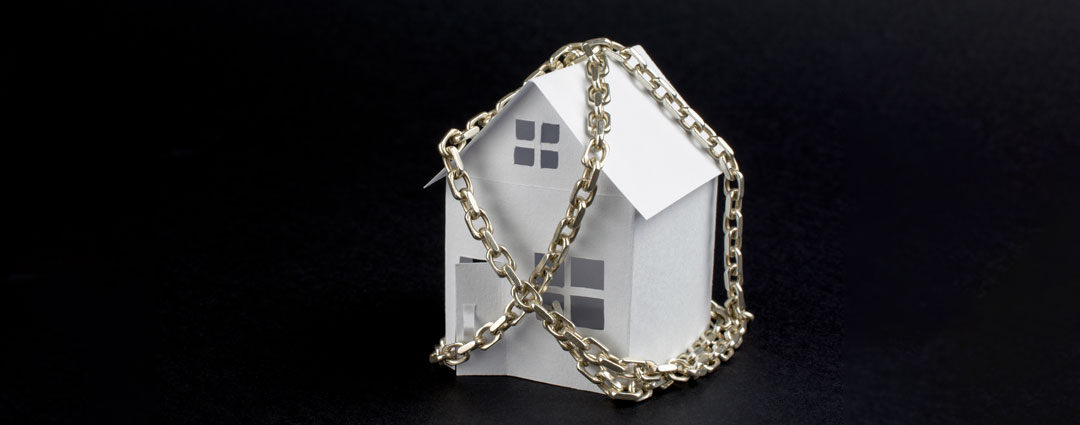 IRS property seizure and legal rights: concept image of a house in chains.